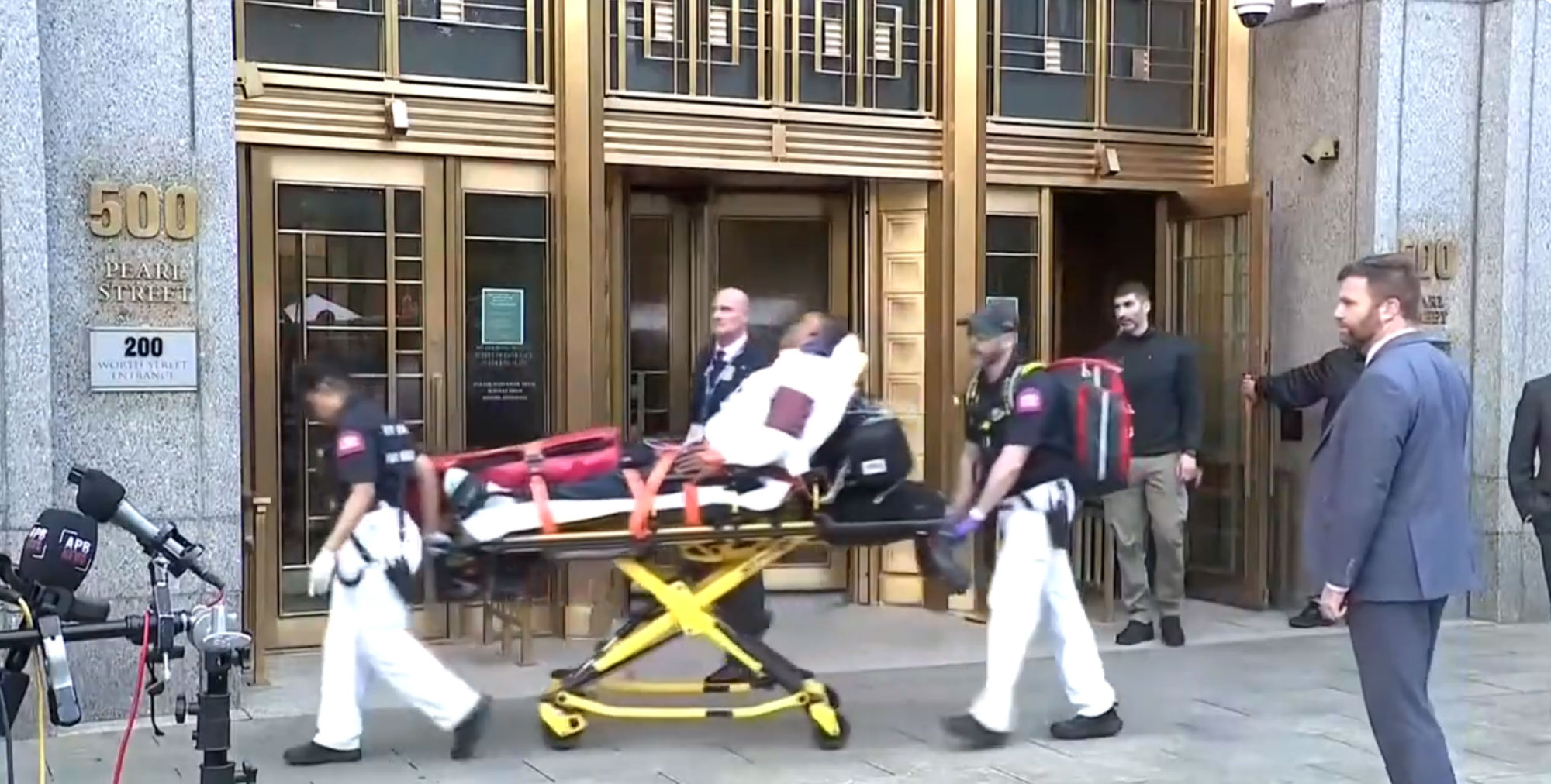A man being removed on a stretcher.