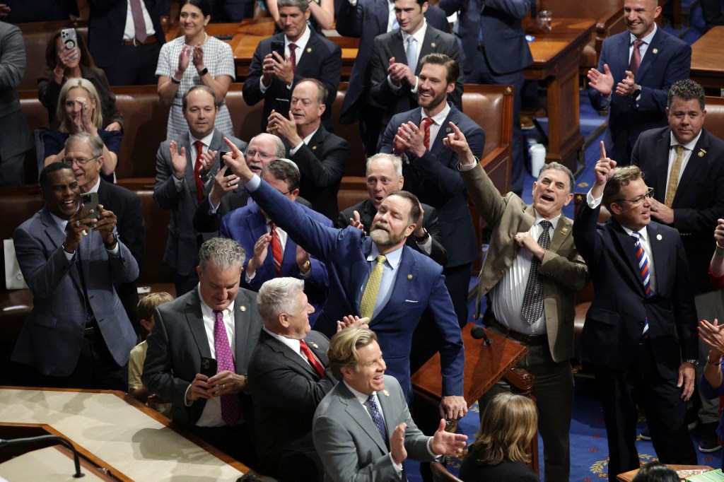House lawmakers celebrating the passage of a budget bill.
