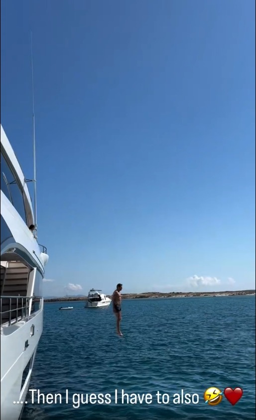 Tom Brady jumps into the sea from a boat. 