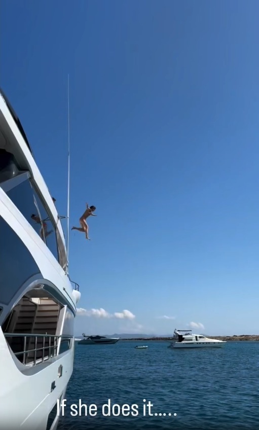 An image of Vivian Brady jumping off a boat. 