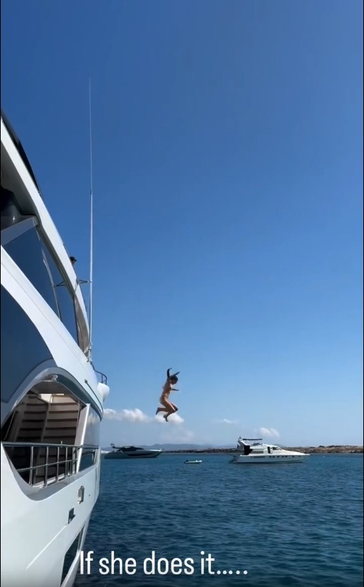 Vivial Brady leaps into the ocean from a yacht. 