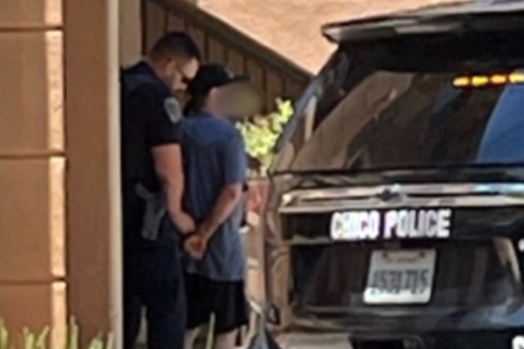 A man in handcuffs being arrested by a Chico police officer.