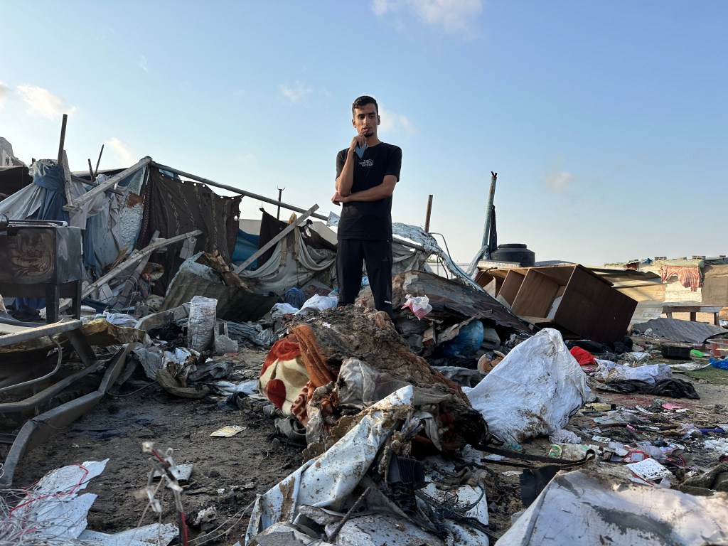 Palestinians inspect the damage at the site of an overnight Israeli air strike on a tent sheltering displaced people, in Khan Younis, southern Gaza Strip, July 2, 2025