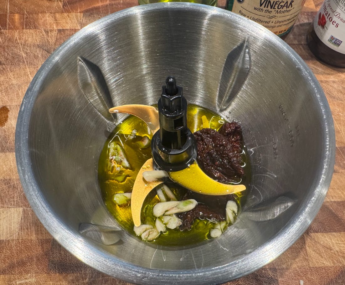 The dressing for Ina Garten's pasta salad, in a food processor.