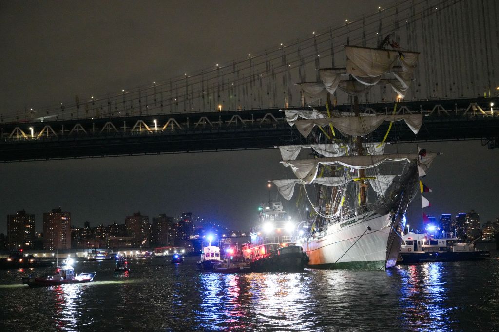 Emergency response members work at the site of Mexican Navy ship Cuauhtemoc's collision with the Brooklyn Bridge in New York.