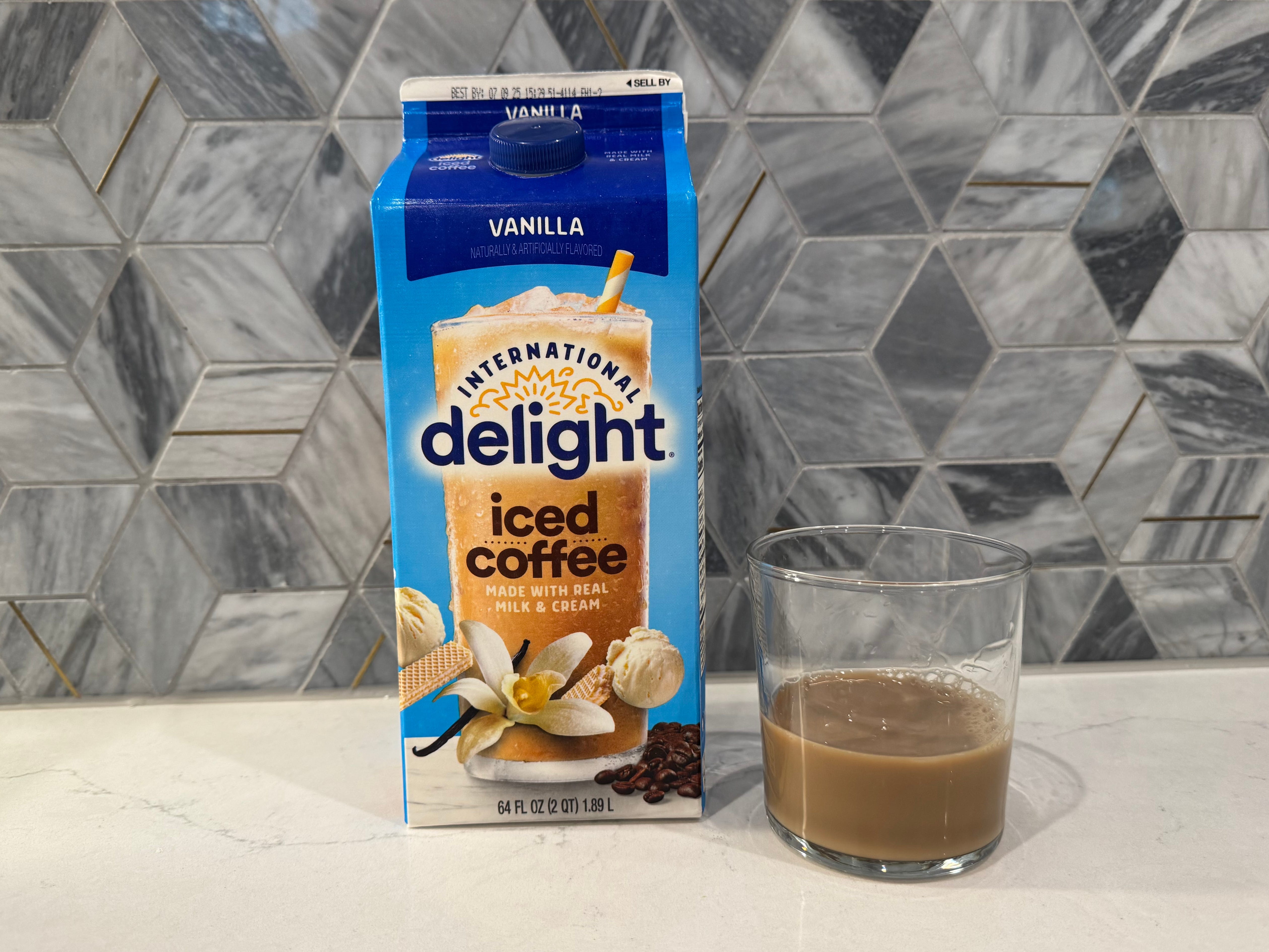 International delight vanilla iced coffee bottle next to glass of iced coffee