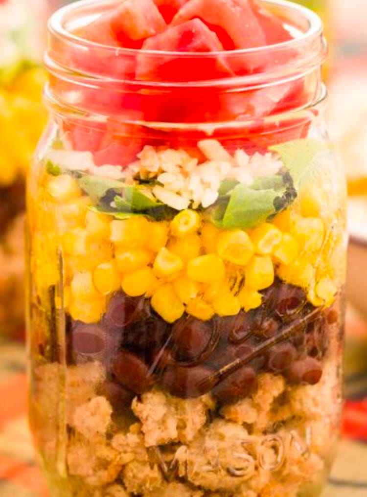 jar with layered salad in it