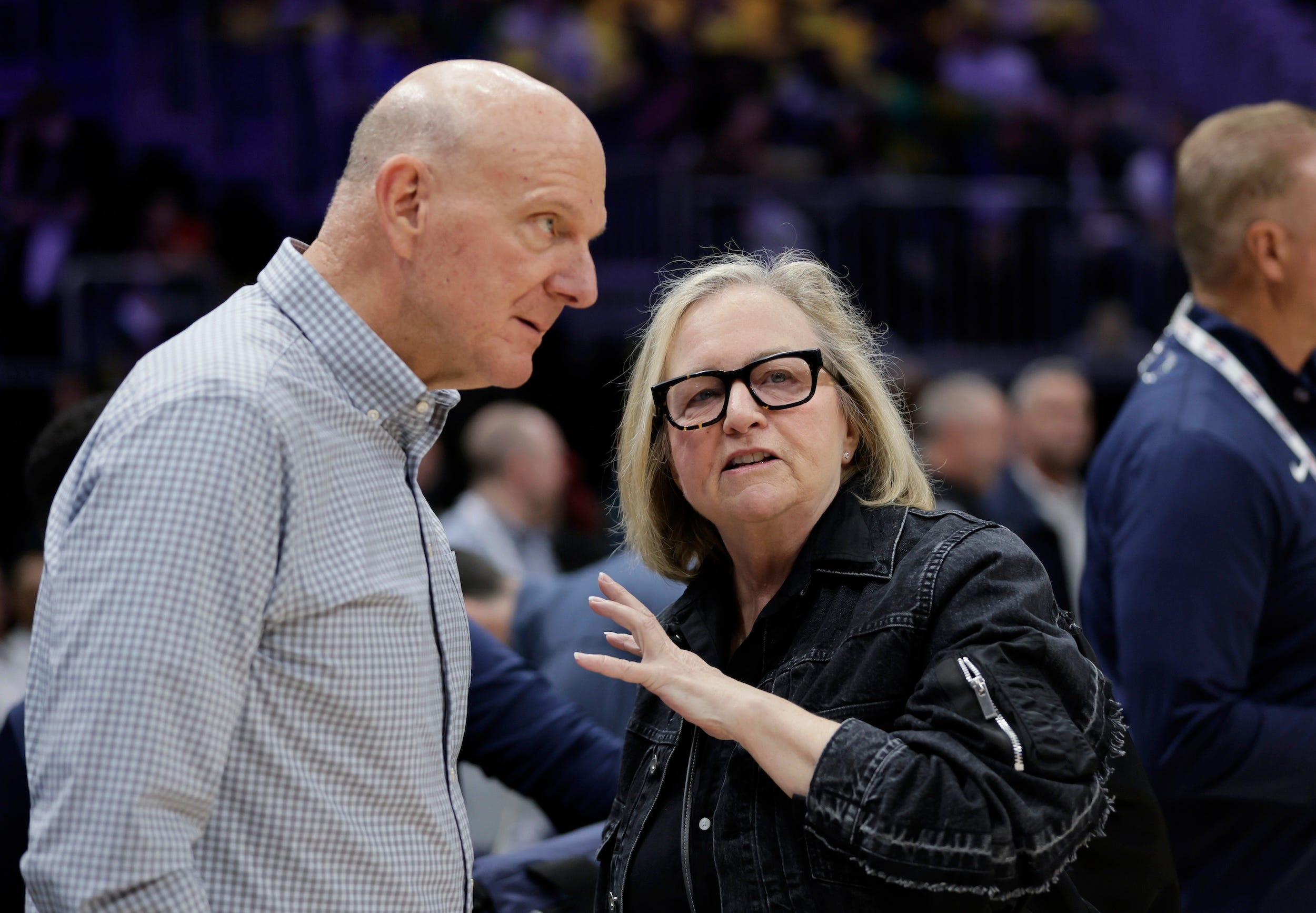 Steve Ballmer and Jody Allen talk before a preseason NBA game