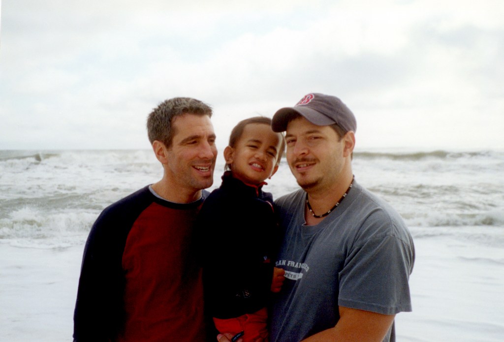 Danny Stewart (left), Peter Mercurio and their young son Kevin at the beach. 