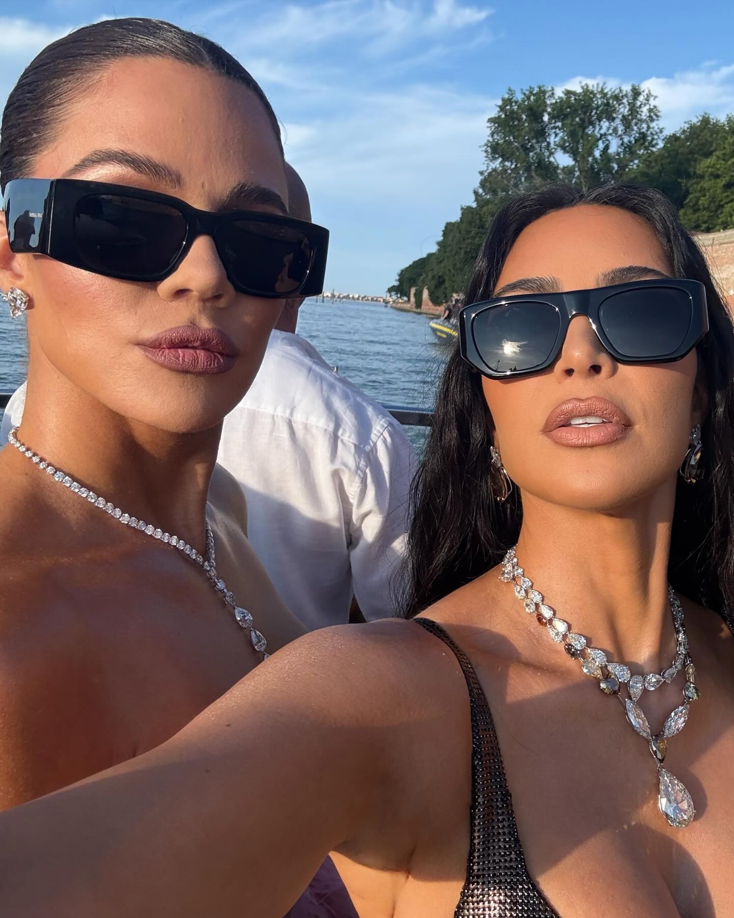 Khloé and Kim Kardashian wearing diamond necklaces