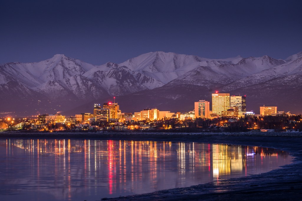 Anchorage skyline at twilight, reflected in Cook Inlet.