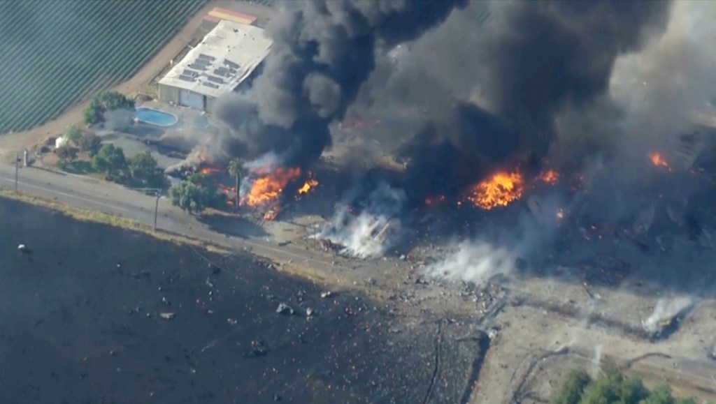 Aerial view of a fireworks warehouse explosion.
