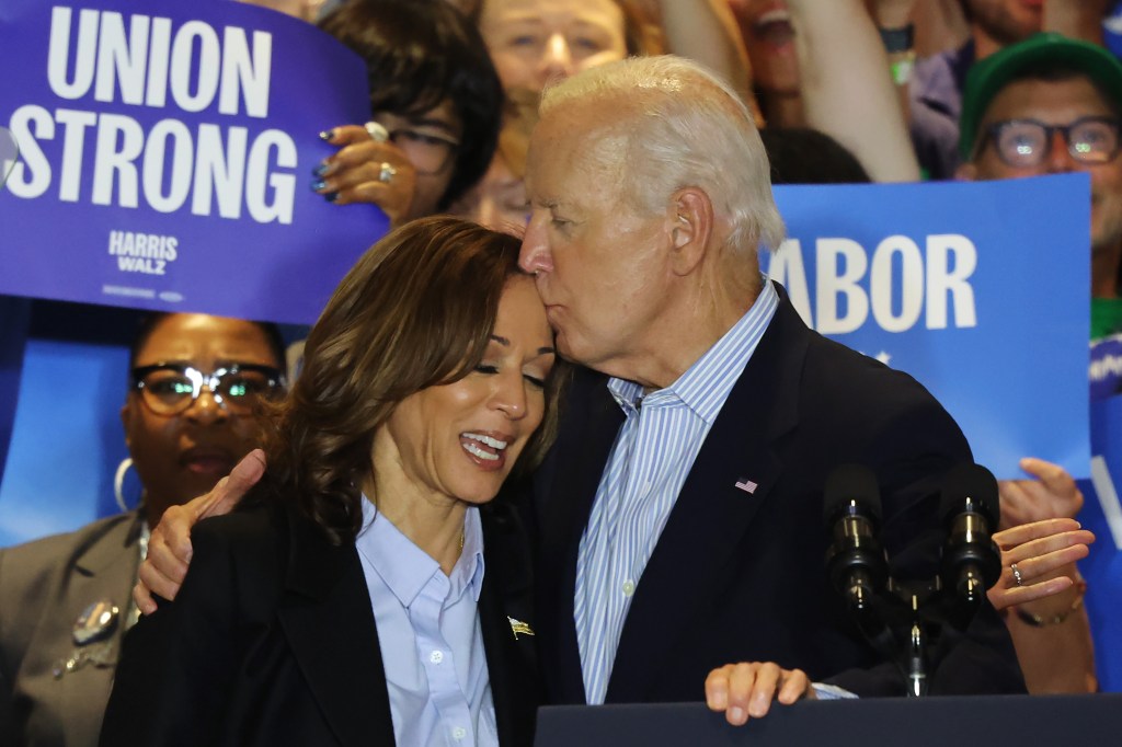 President Biden kisses Vice President Harris on the forehead at a campaign event.