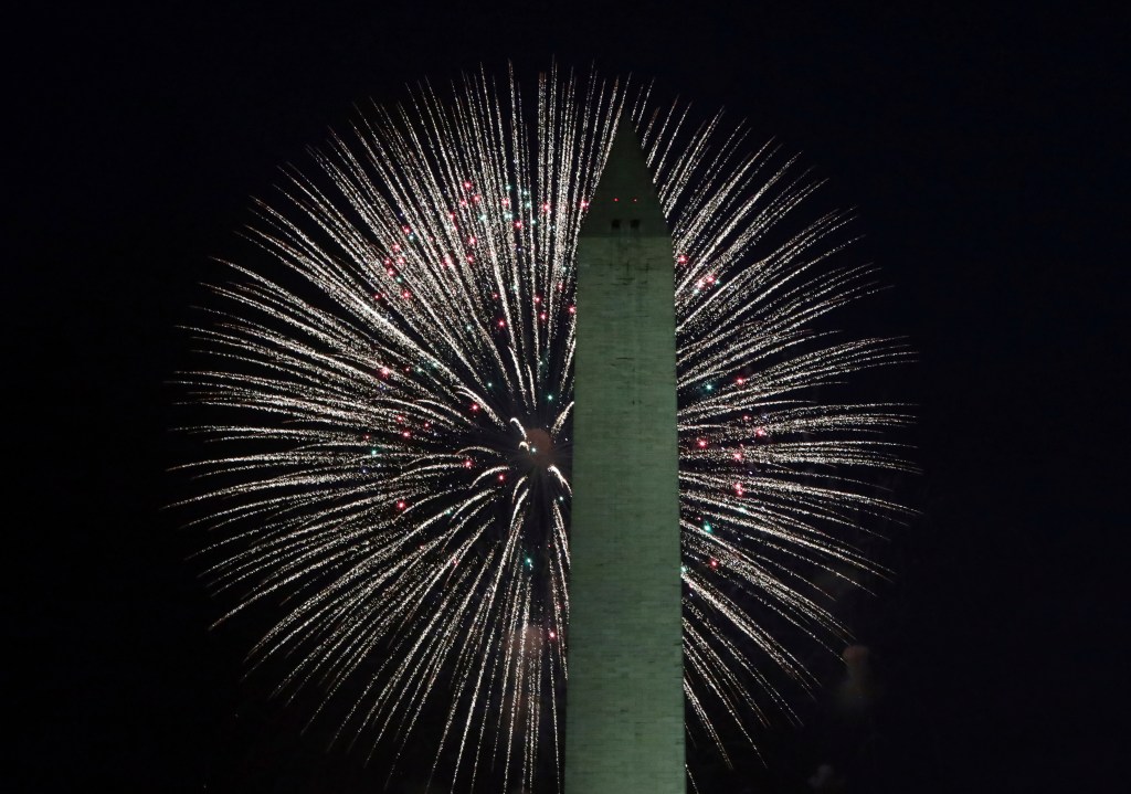 A firework explodes behind the Washington Monument on July 4, 2025.