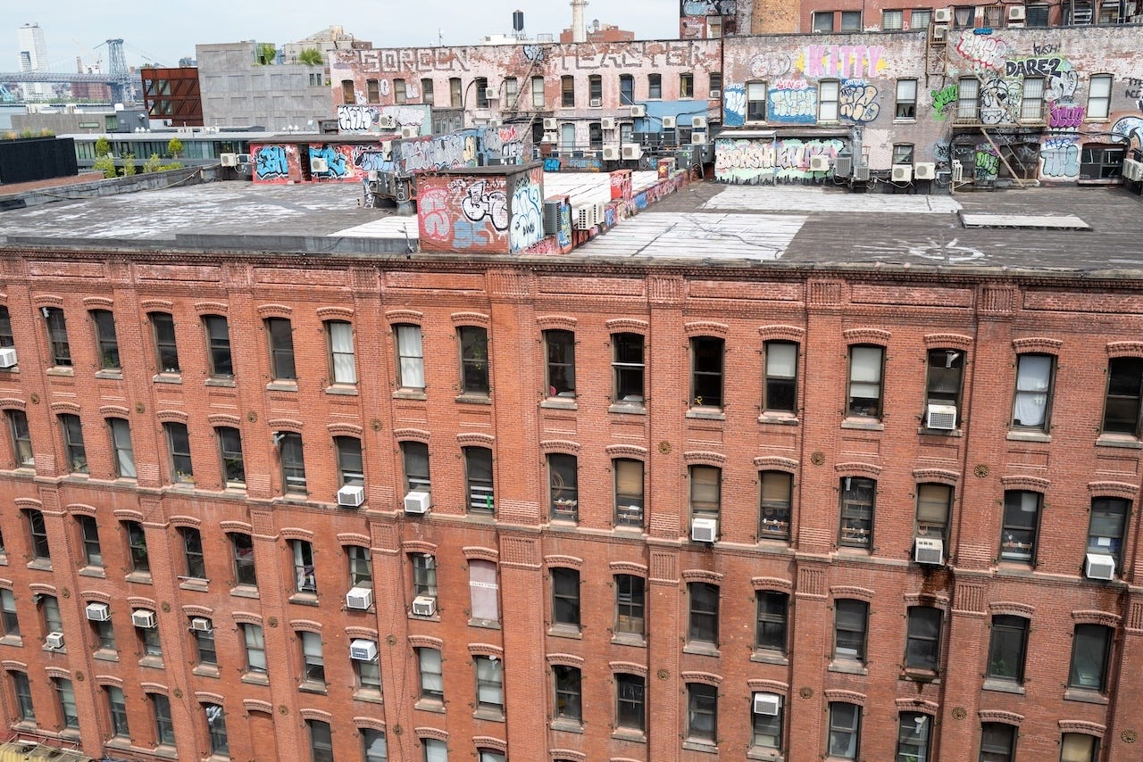 A row of red brick apartments in Brooklyn, New York.