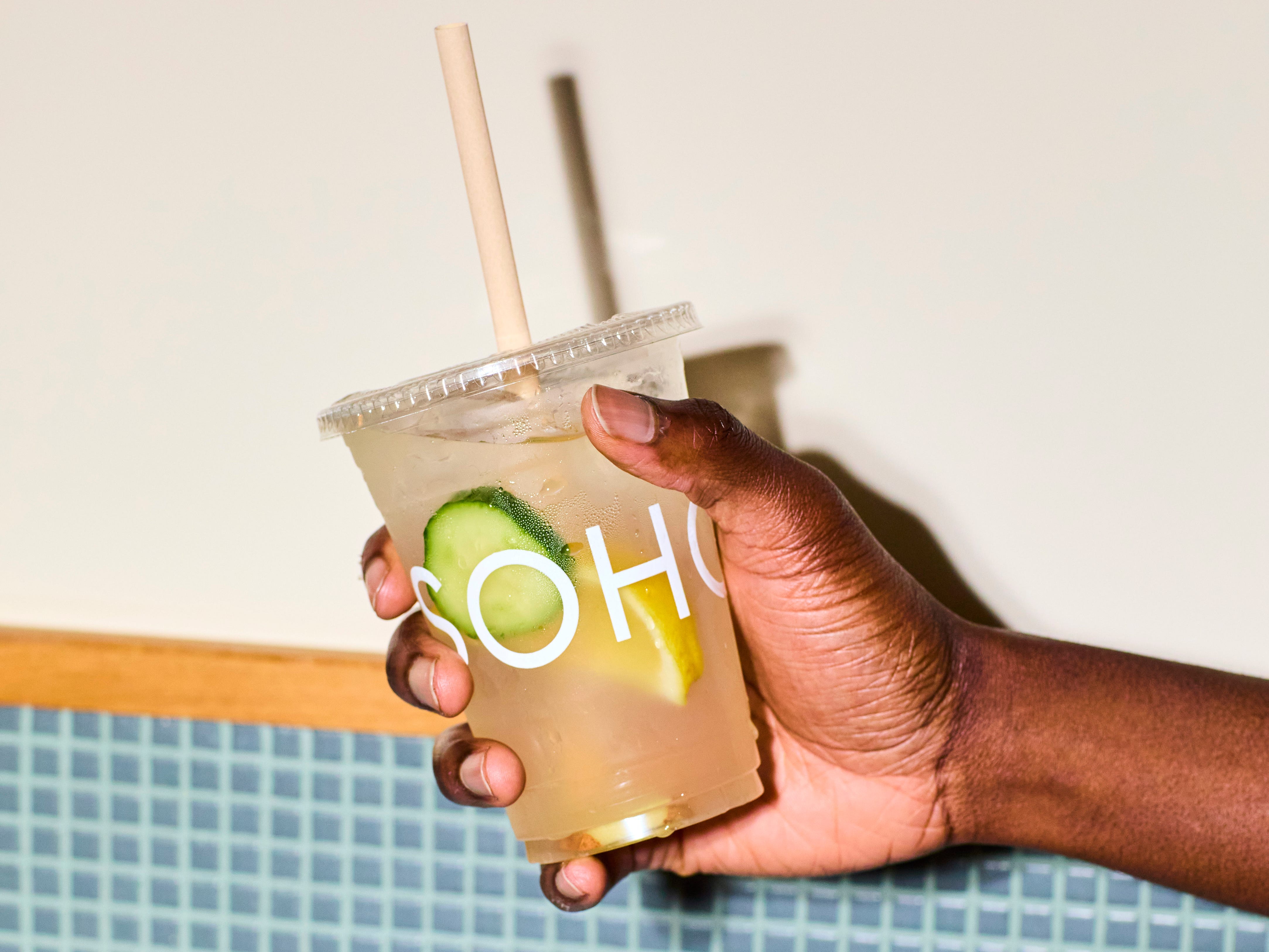 A cup of water with cucumber and lemon.