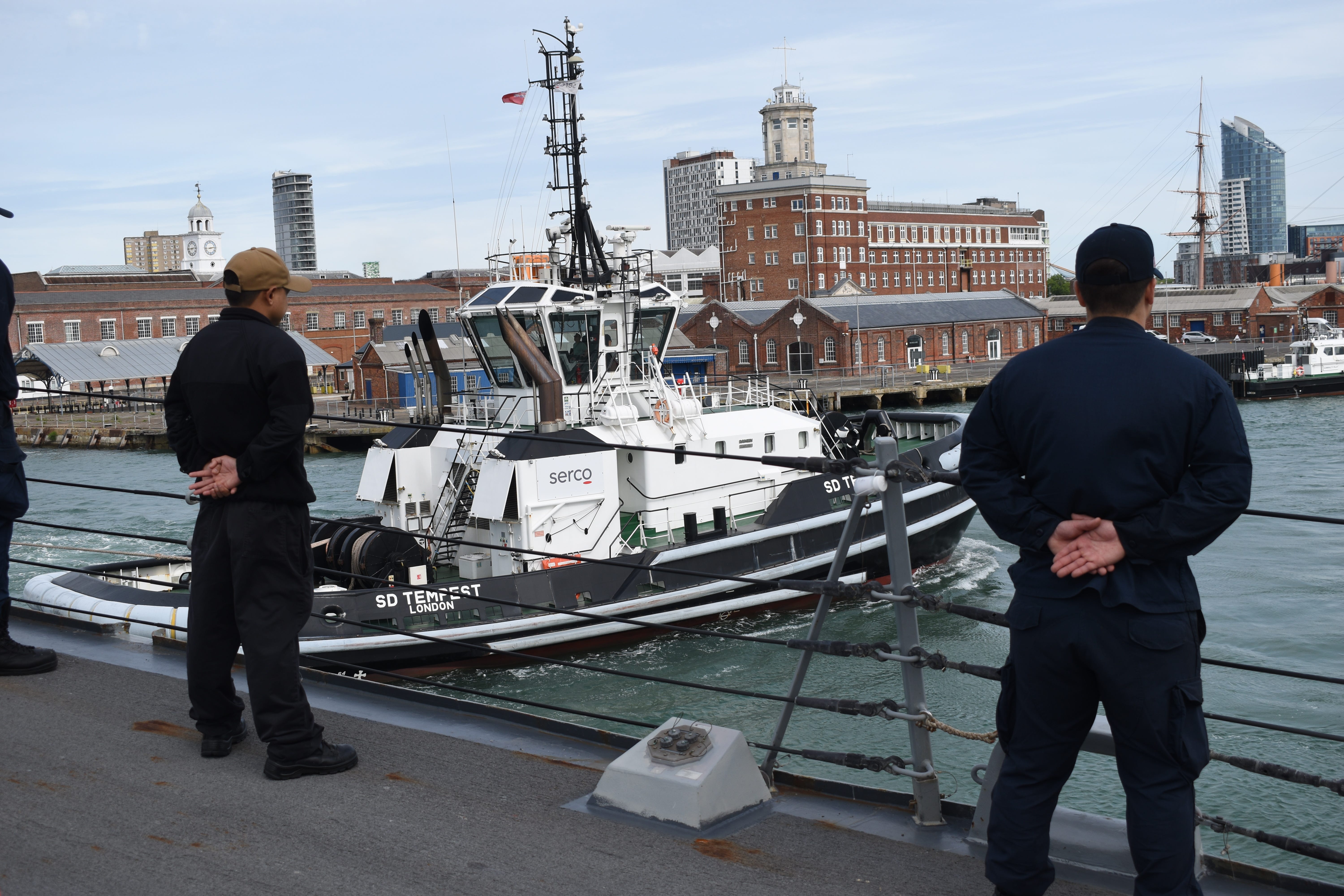 Sailors watch as the Navy destroyer USS Thomas Hudner leaves England in May 2025.