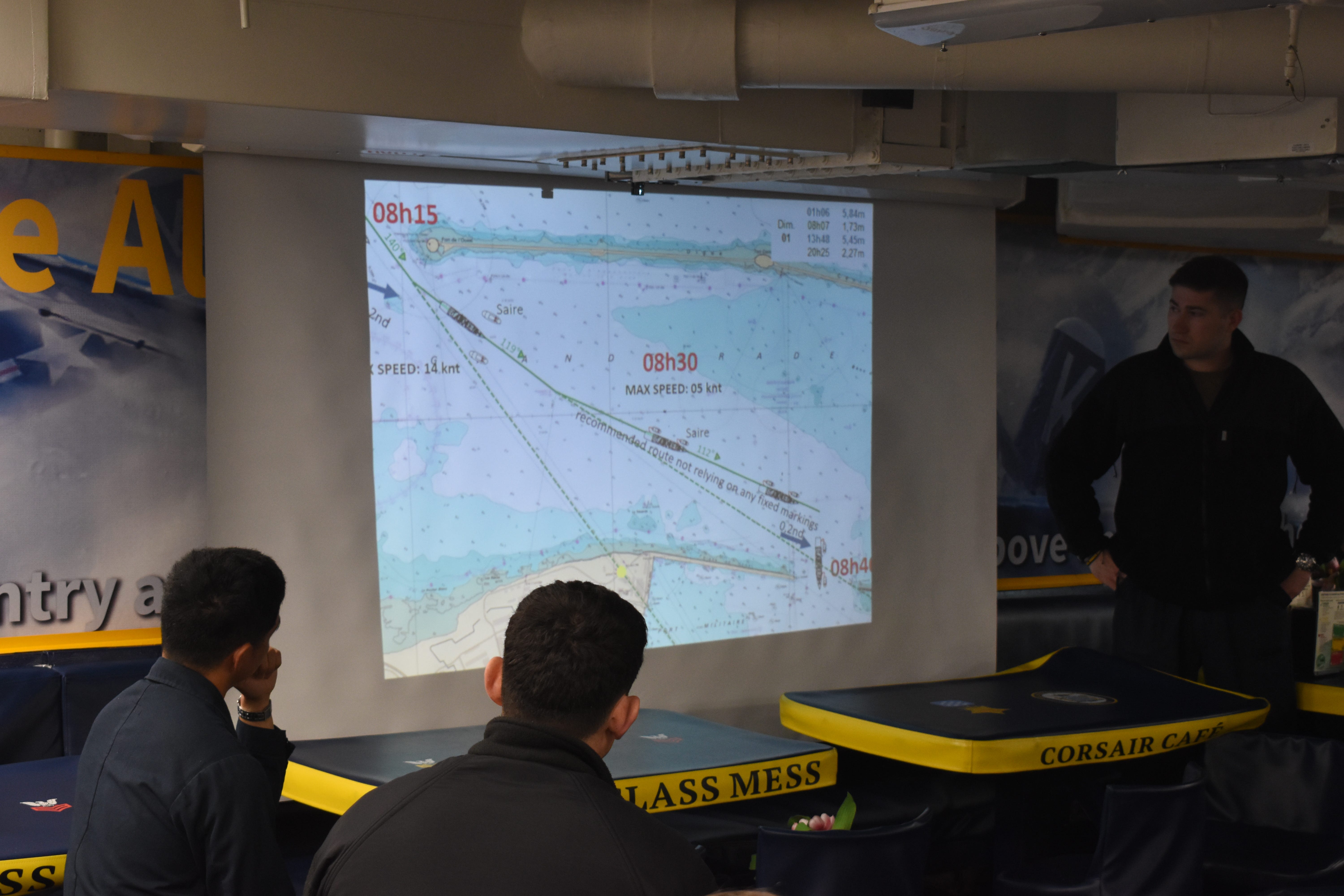 Sailors discuss the plan for arrival in port aboard the Navy destroyer USS Thomas Hudner in June 2025.