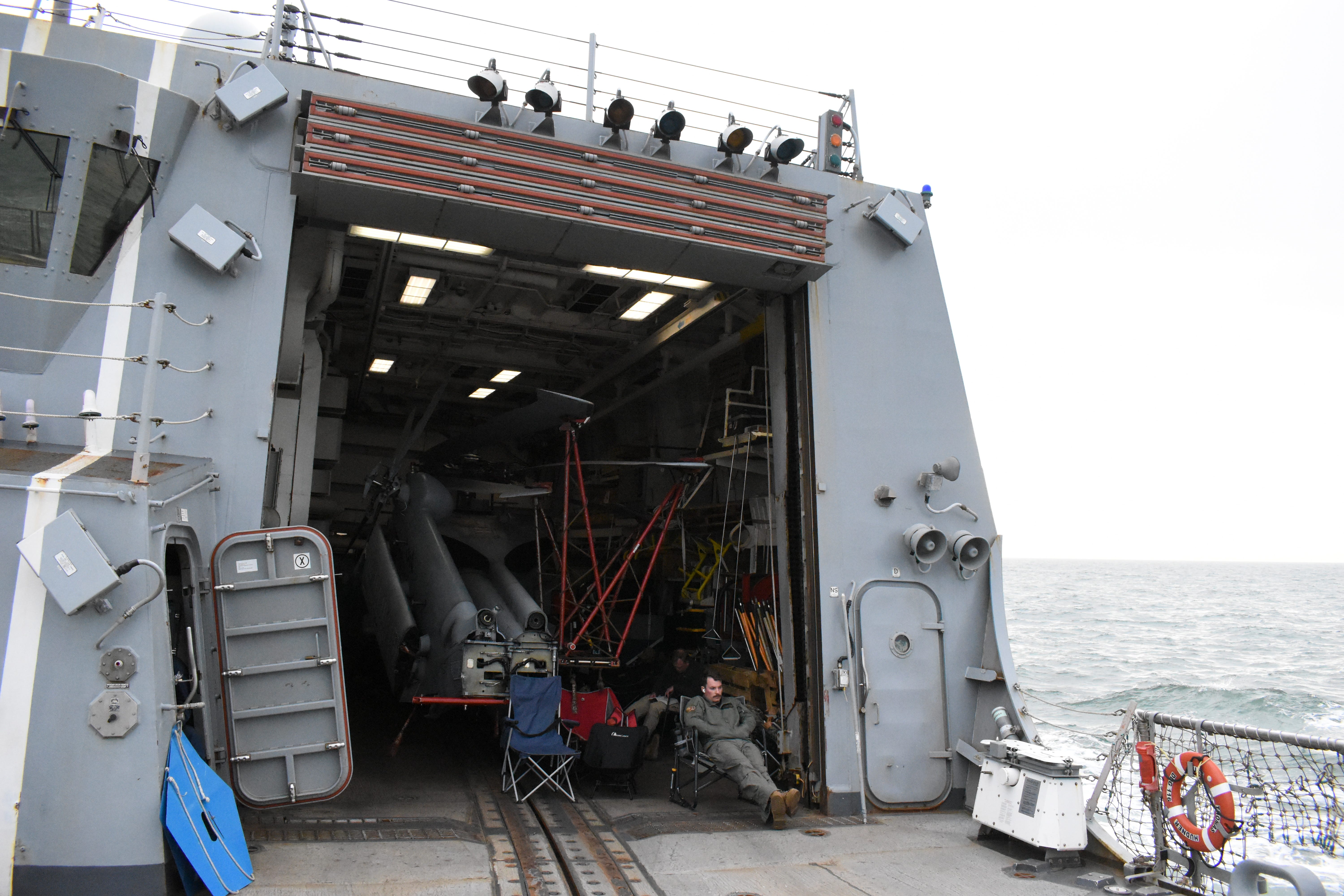 Sailors rest on the Navy destroyer USS Thomas Hudner in June 2025.