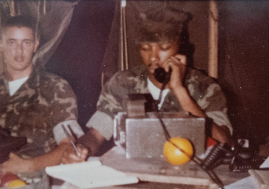 Corley as a young sergeant on duty manning the phone at camp lejeune