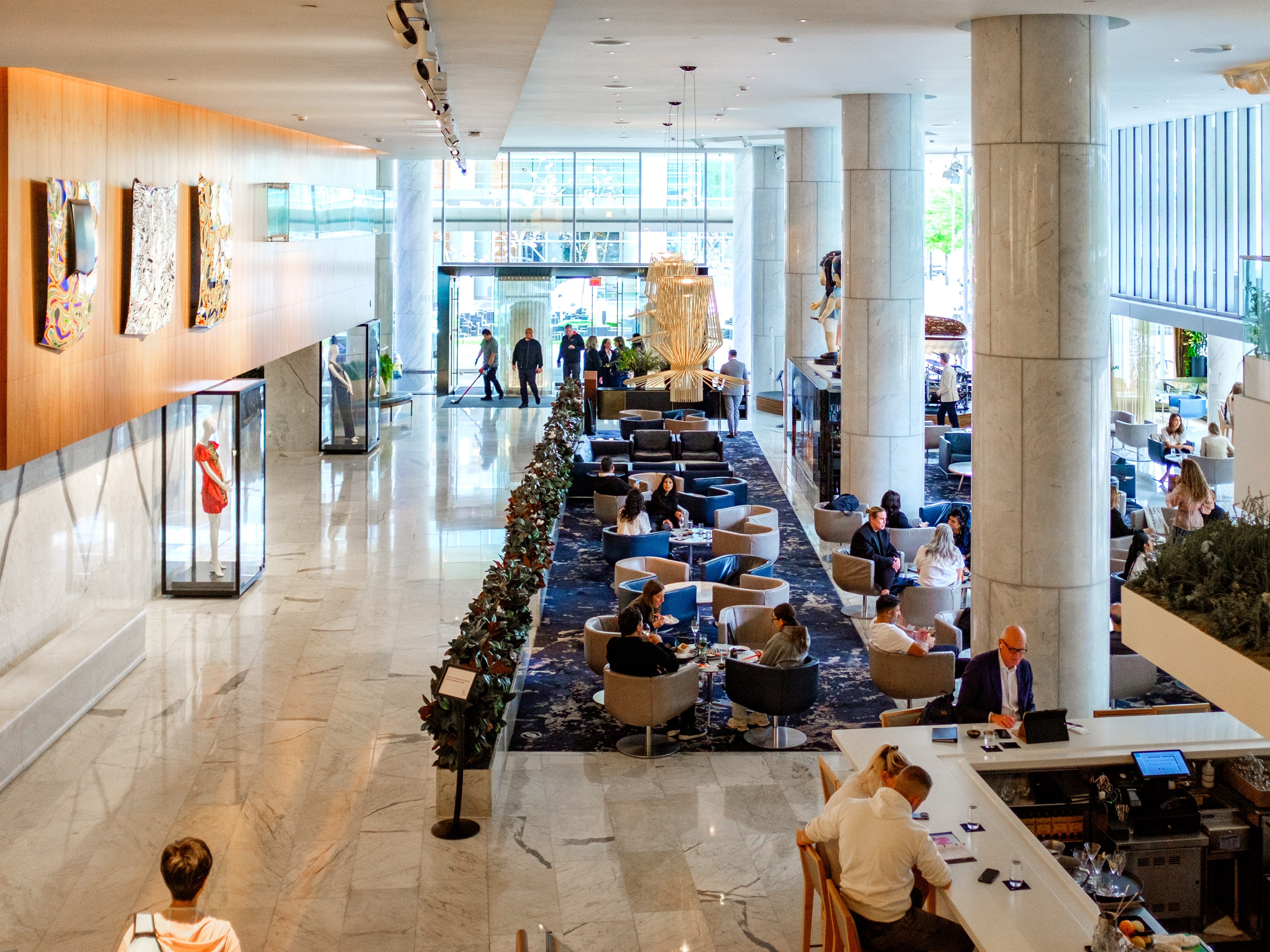 People gather in the lobby at the Fairmont Pacific Rim hotel in Vancouver