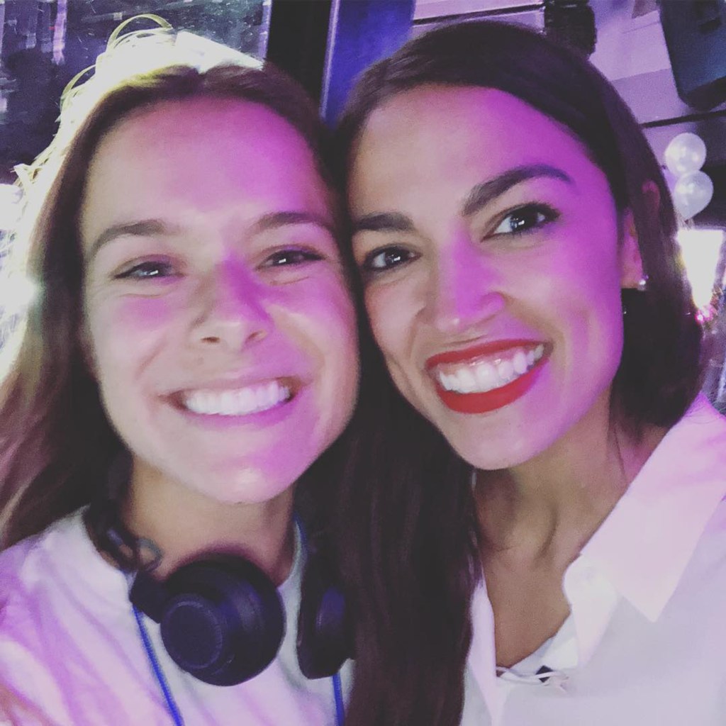 Lucy Biggers and Alexandria Ocasio-Cortez smiling together.