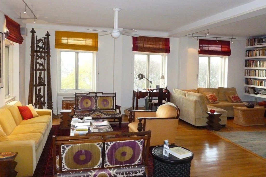 Living room with tan sectional sofa, yellow sofa, and patterned armchairs.