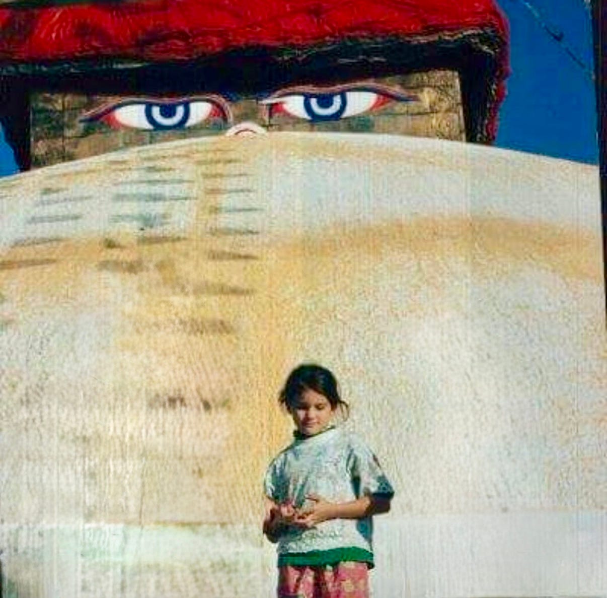 Little girl by sculpture