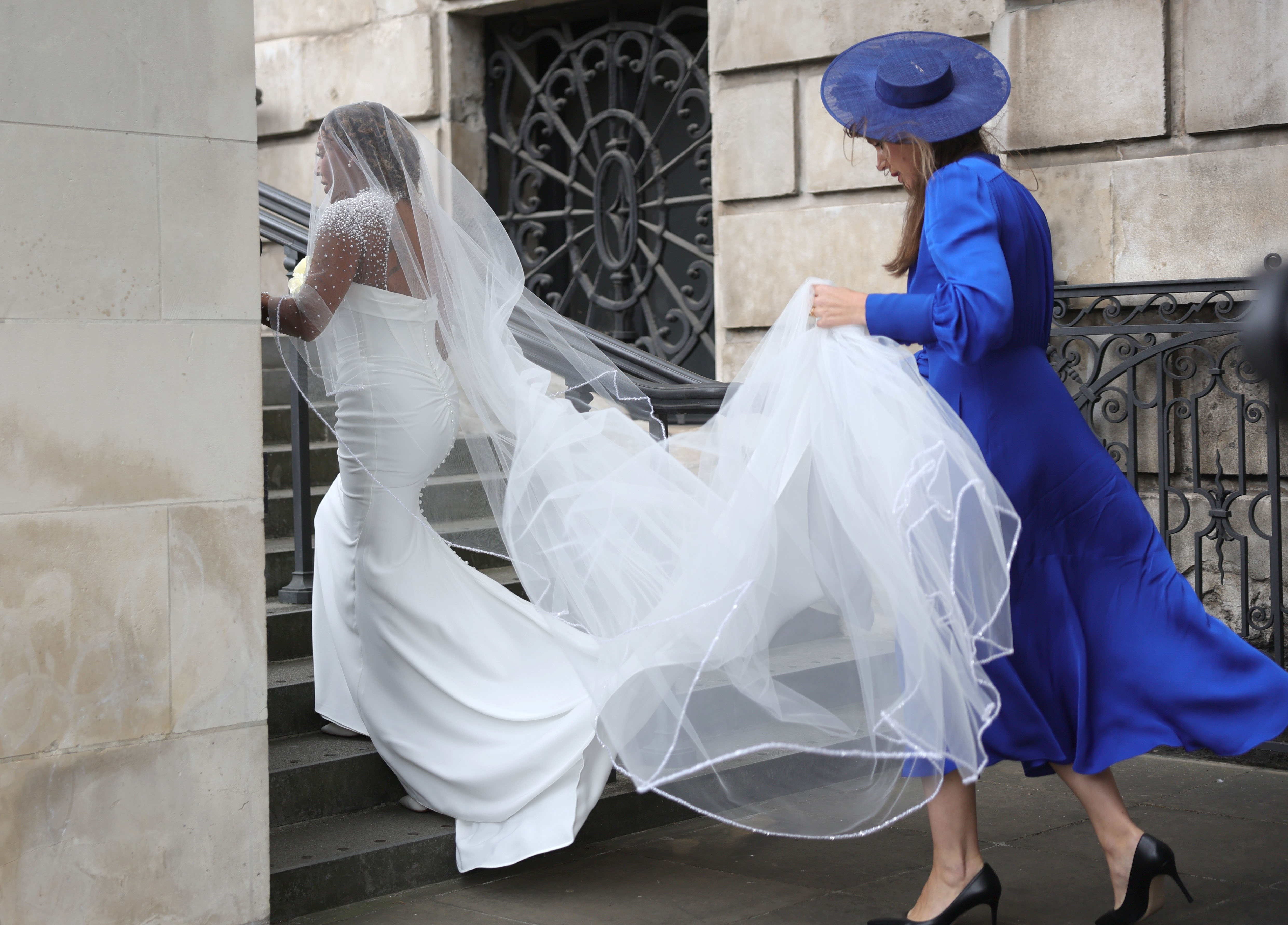 Mel B and someone holding her dress.
