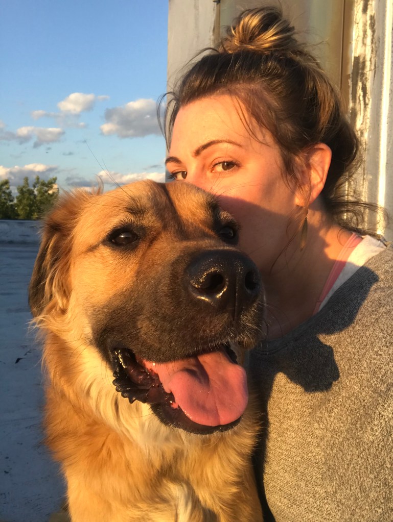 Woman embracing her dog.