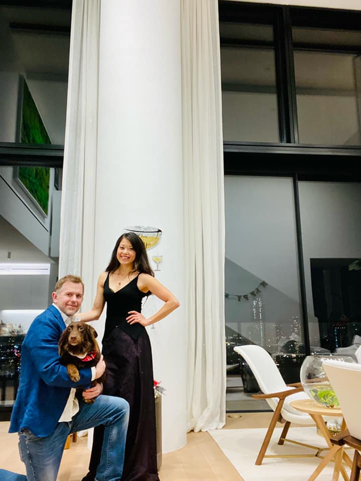 the couple pose with their dog