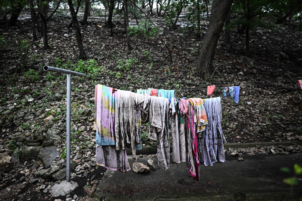 Muddy towels and clothes hanging on a clothesline after a flood.
