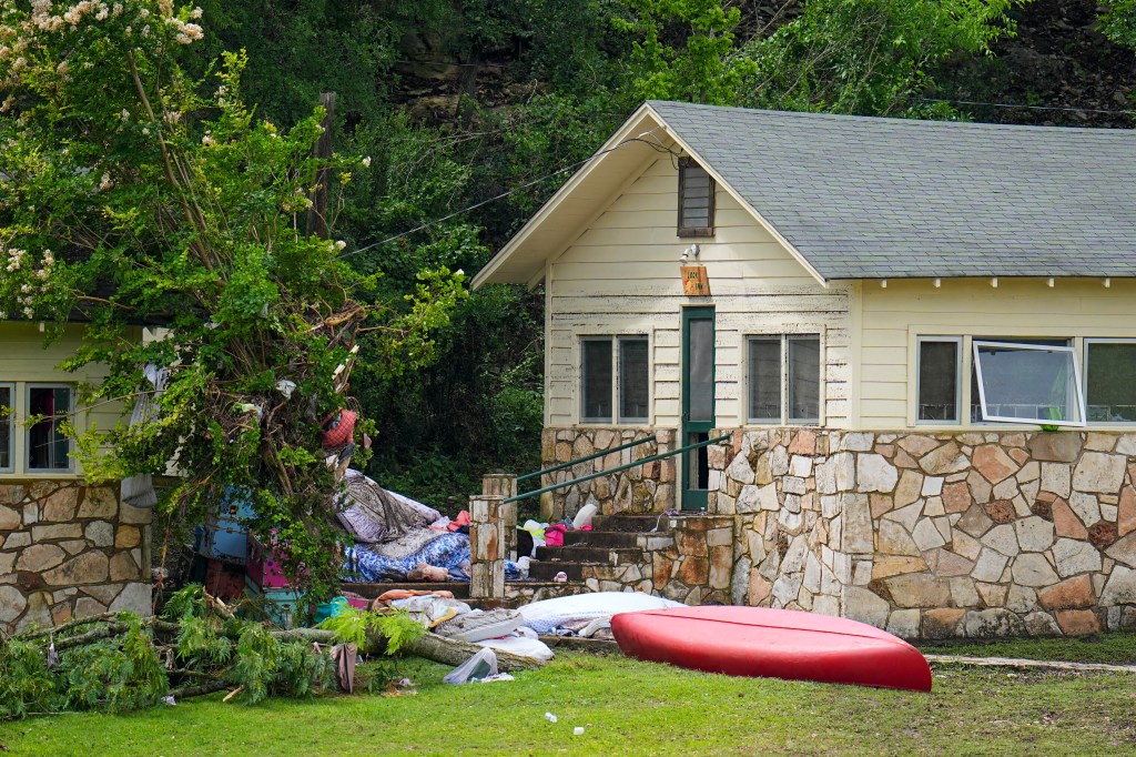 Flood debris outside a cabin.