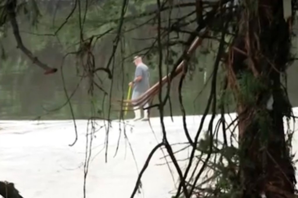 Man searching near a body of water.