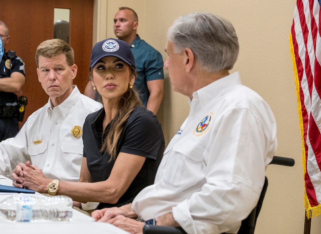 Nim Kidd, Kristi Noem, and Greg Abbott at a news conference.