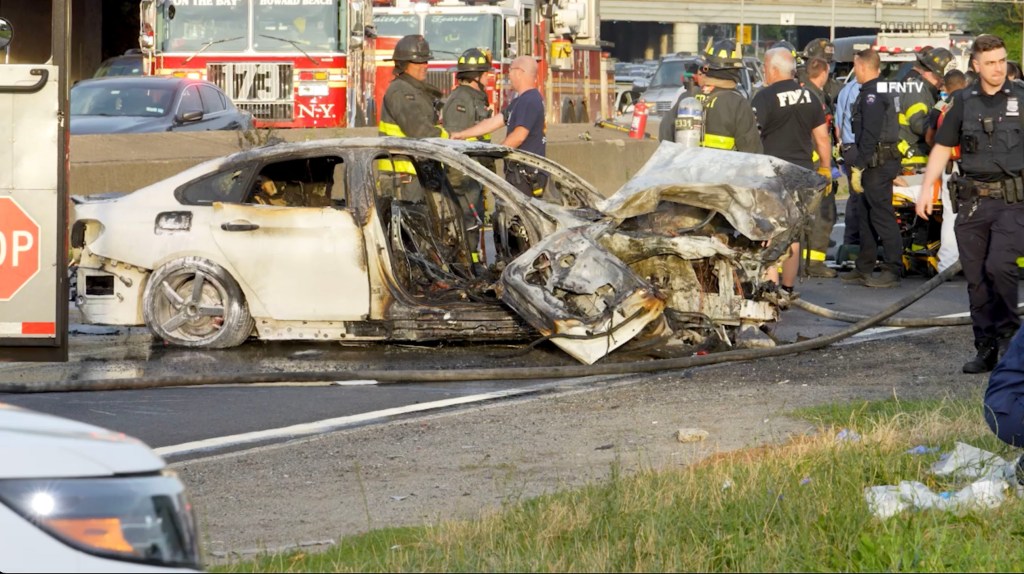 Burned-out car at the scene of a multi-vehicle accident in Queens, NY.