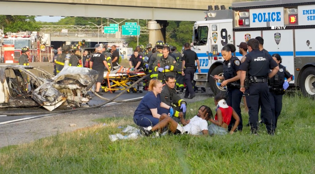 Aftermath of a multi-vehicle crash with injuries and fire.