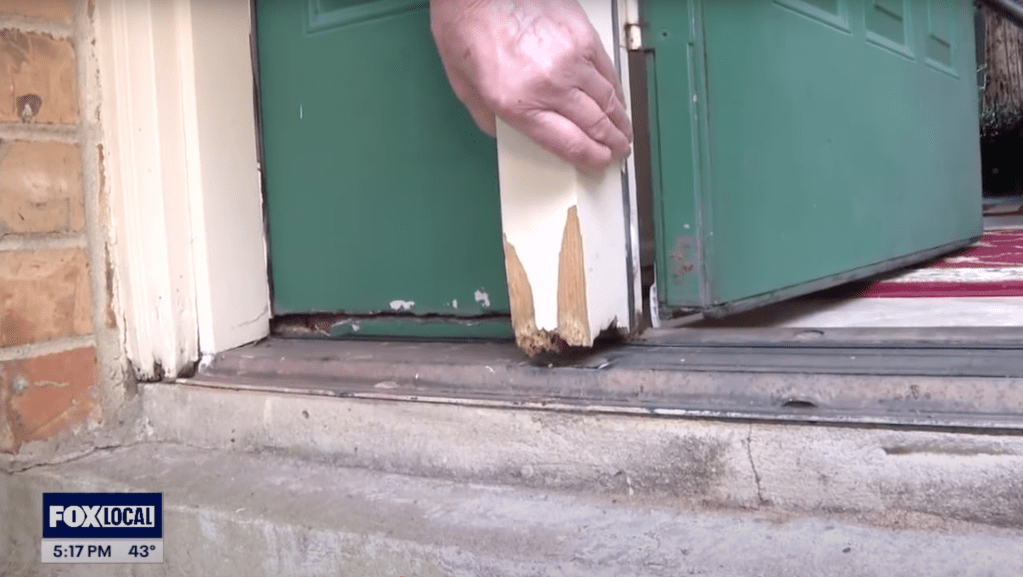 Damaged door frame and threshold.