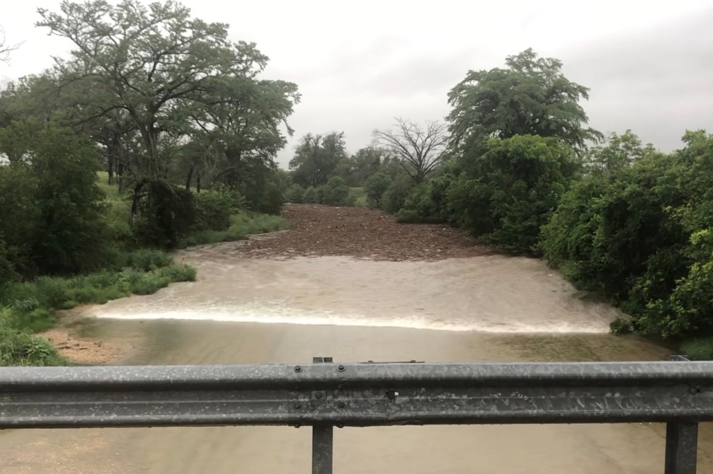 Floodwaters rushing through the Guadalupe River.