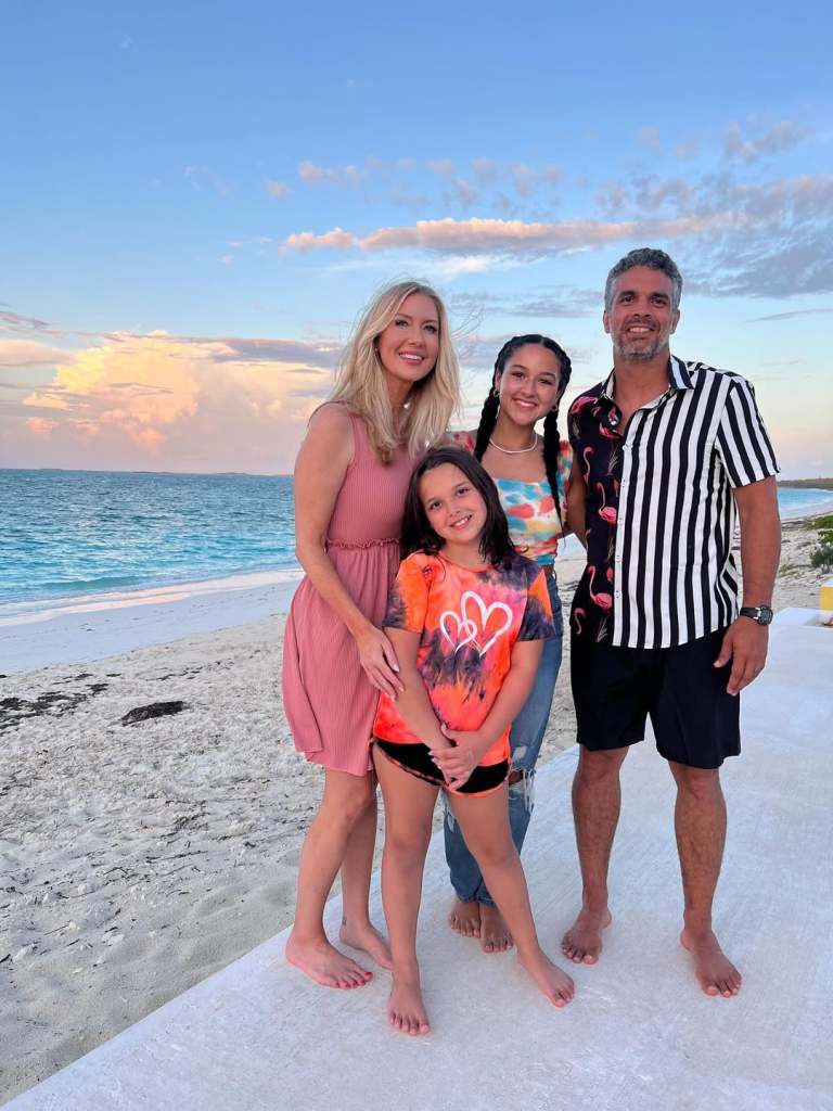 Brent Slough on a beach with his wife, Whitney, and their two daughters.