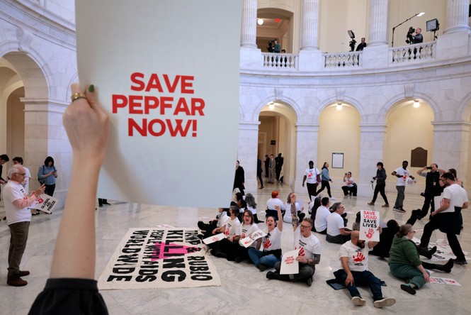 Someone holds a sign that says 