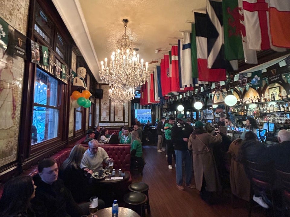 Interior of a pub with flags hung from ceiling