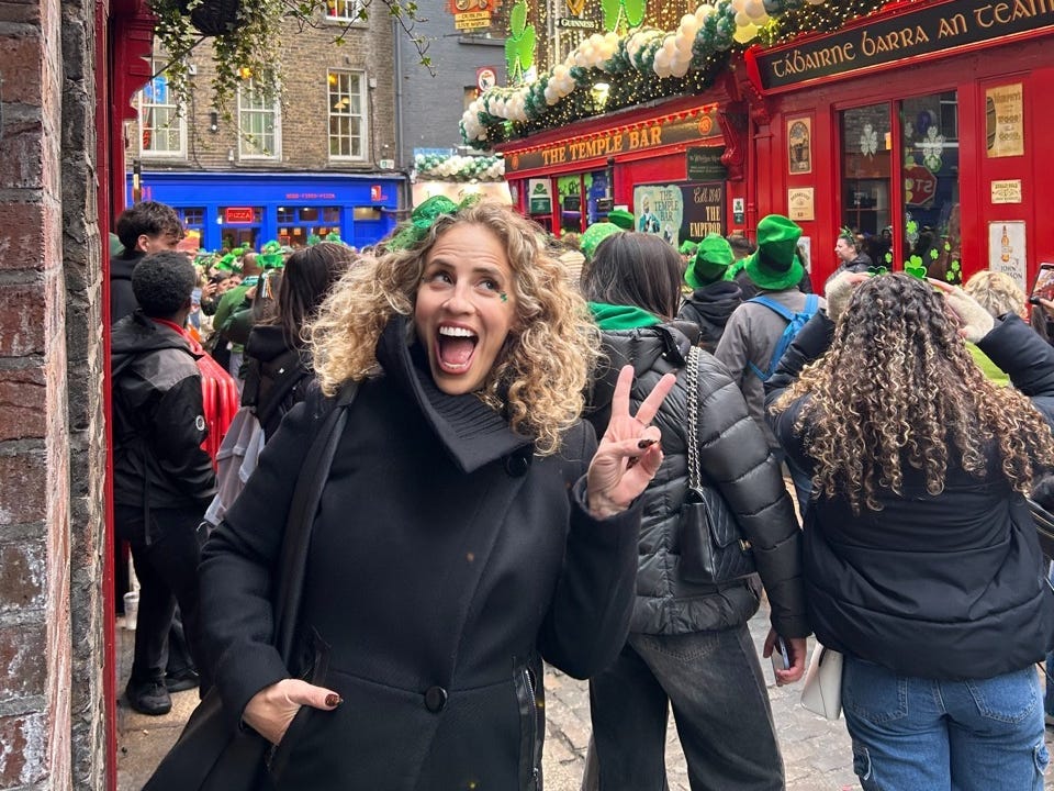 Author Alesandra Dubin smiling on busy street in Dubling