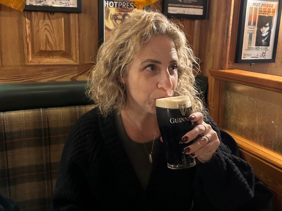 Author Alesandra Dubin sipping a Guiness in a bar