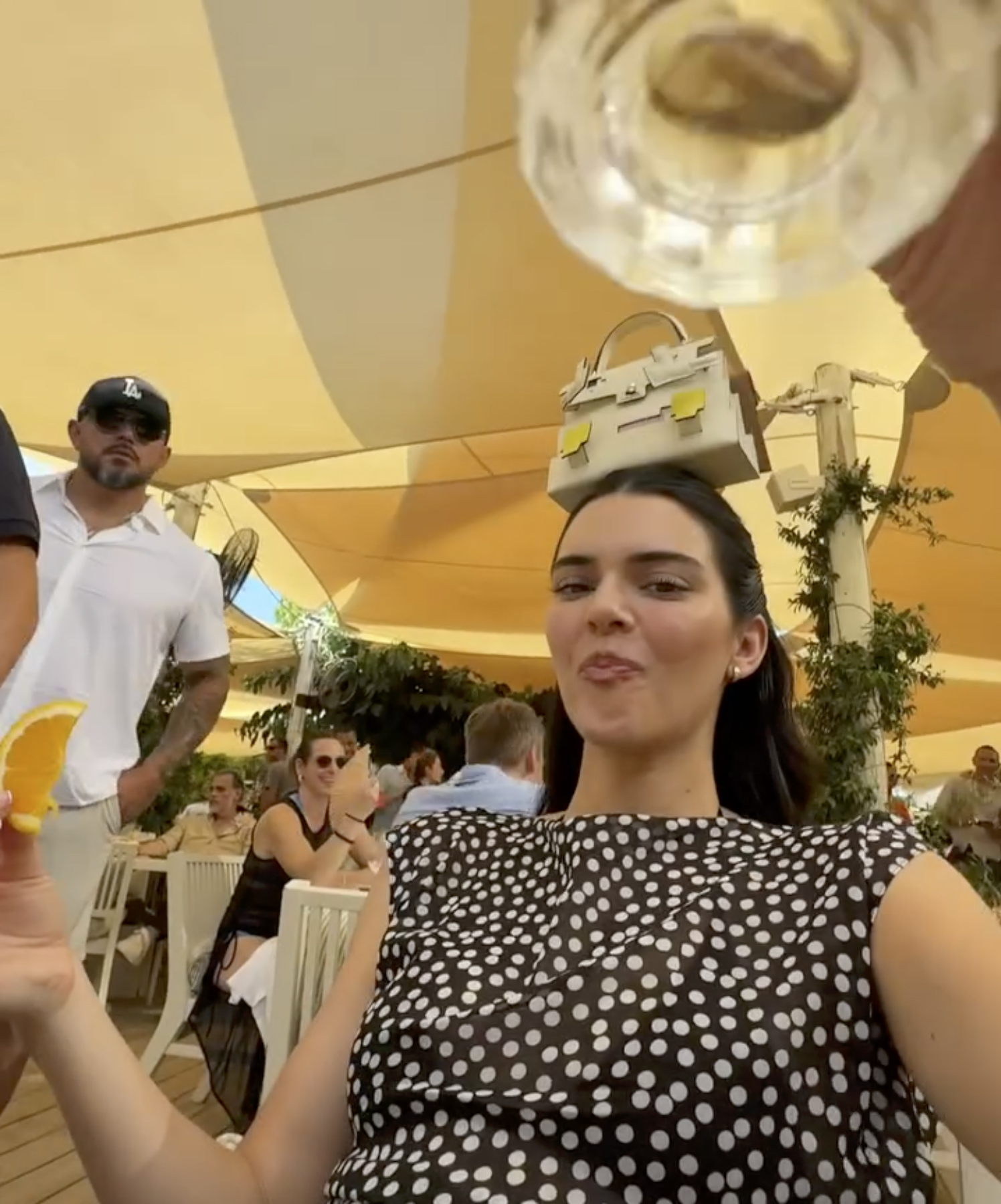 Kendall Jenner with a handbag on her head