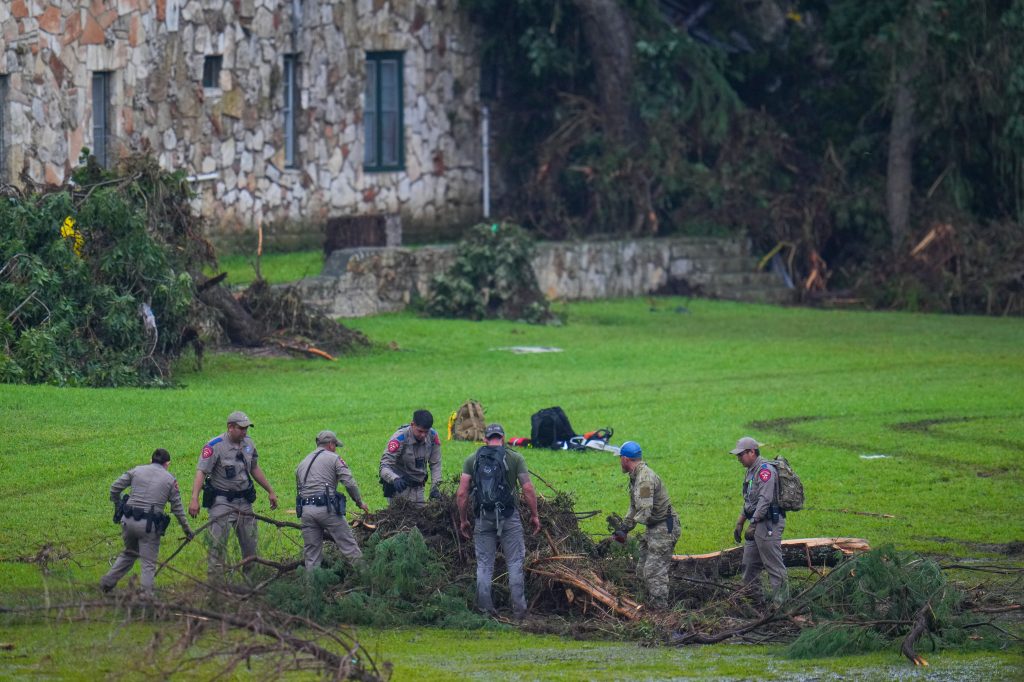 Emergency personnel clearing debris after a flash flood.