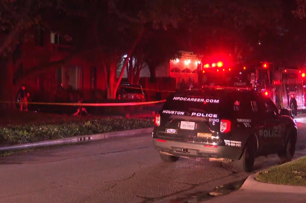 Houston police at a nighttime crime scene.