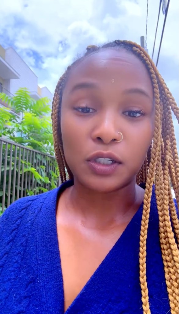 Woman with blond braids speaking to camera.