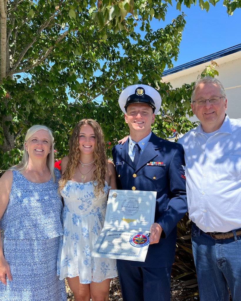 Ruskan with his family after passing rescue swimmer school last year.