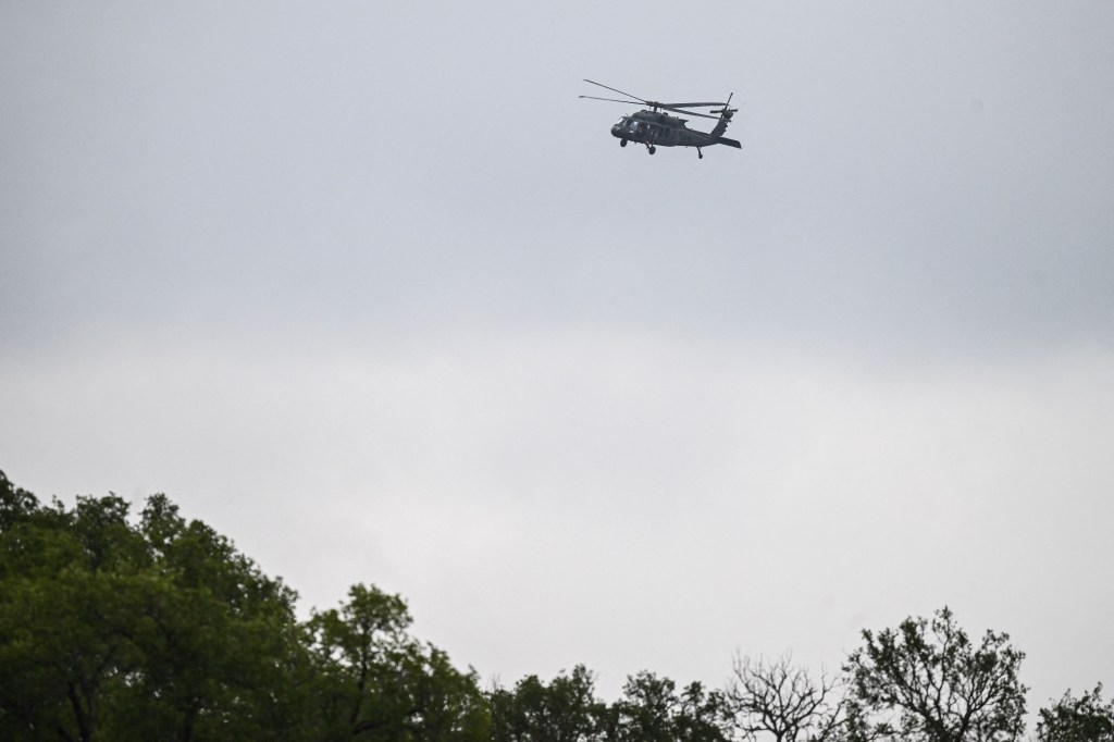 A helicopter flying over Camp Mystic to search for missing flood victims on July 6, 2025.